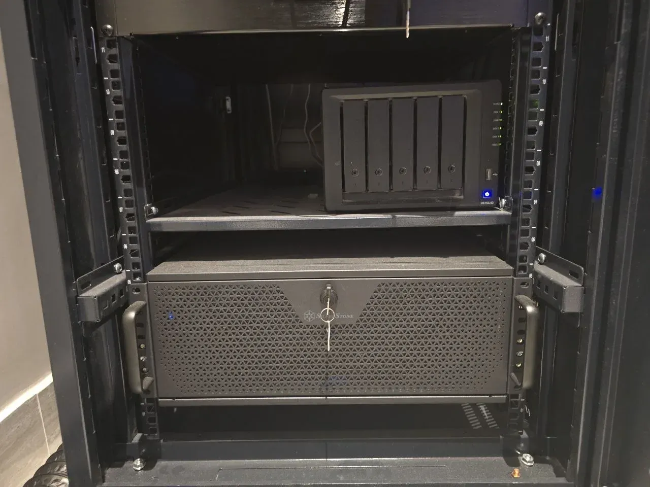 Synology DS1522+ NAS with five matched IronWolf Pro drives on a rack shelf