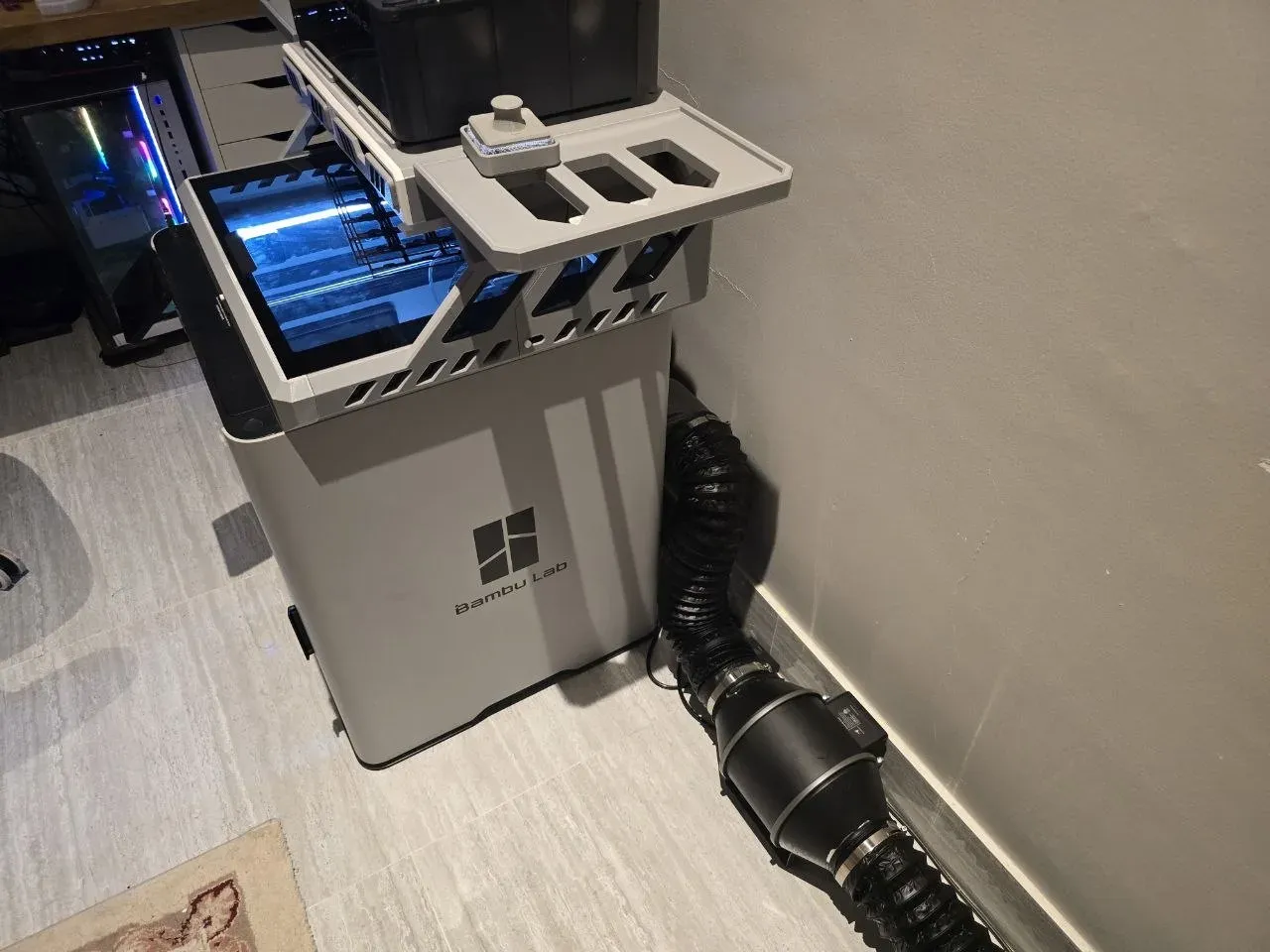 Bambu Lab H2S 3D printer with an inline-fan exhaust duct running off the back